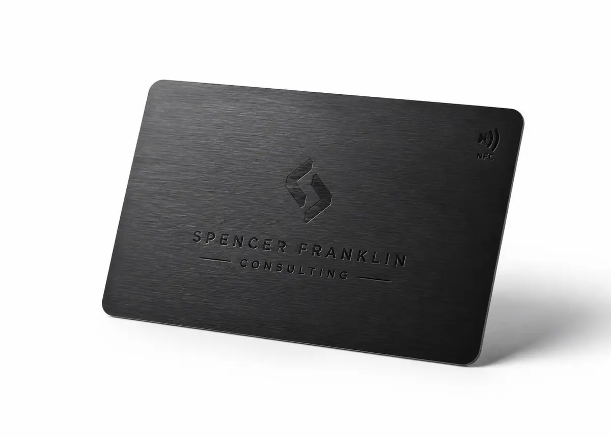 Brushed black metal NFC business card in studio light